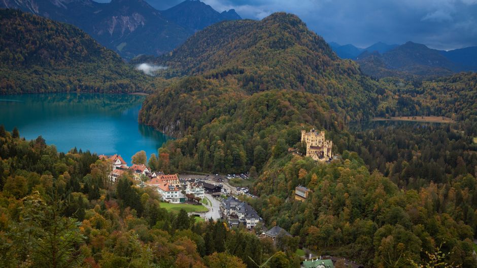 Breathtaking panoramic view of Lake Alpsee, Hohenschwangau Castle, and Bavarian landscape in Schwangau, Germany.