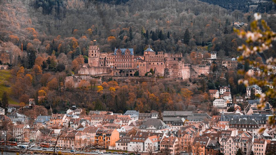 View of Heidelberg Castle and town with vibrant fall colors in Germany.